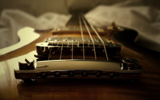 Guitar neck closeup table background 2 - a close up of a guitar neck free wallpaper
