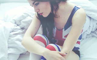 Woman sitting bed legs crossed 8 - pale free wallpaper