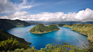 Lake surrounded mountains trees cloudy - a blue body of water free wallpaper