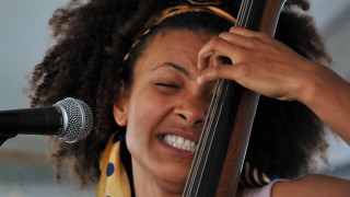 Woman holding bass microphone smiling - facial muscle free wallpaper