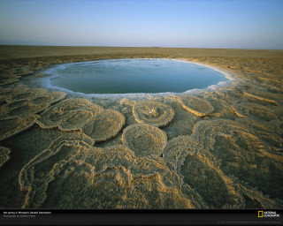 Large crater desert plain blue - a blue pool of water free wallpaper