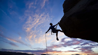 Man climbing cliff rope sunset - extreme illustration free wallpaper