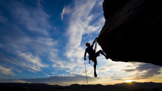 Man climbing cliff rope sky - extreme illustration free wallpaper