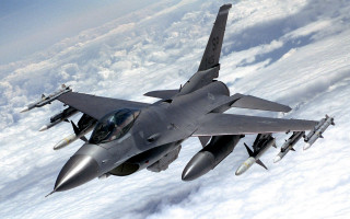 Fighter jet flying above clouds 3 - area free wallpaper