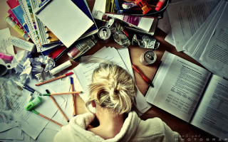 Woman sitting desk papers pencils - hard focus free wallpaper
