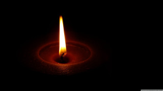 Lit candle dark black background - a candle free wallpaper