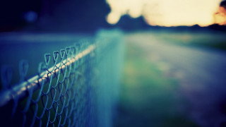 Chain link fence person walking - the other side of it free wallpaper