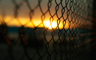 Sunset chain link fence building - the distance behind free wallpaper