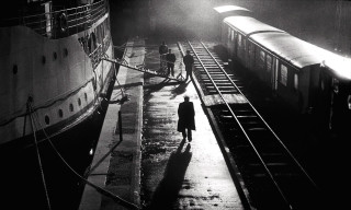 Man walking sidewalk train track - brassaï free wallpaper