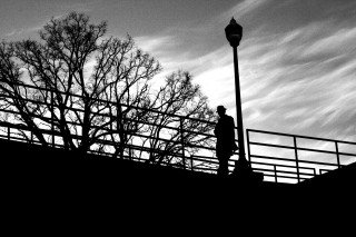 Person walking bridge streetlight bare - derold page free wallpaper