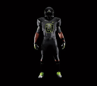 Football player black uniform green - his hands in his pockets free wallpaper