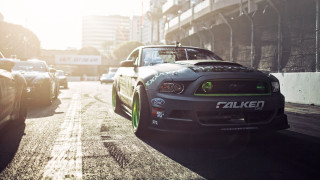 Car driving street tall buildings - angry free wallpaper