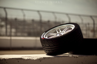 Two tires ledge outside fence - area free wallpaper