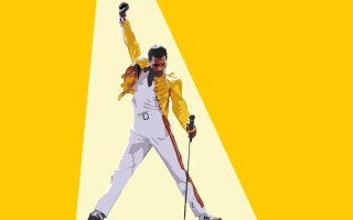Man yellow jacket holding skis - a yellow background behind free wallpaper