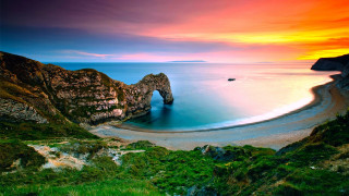 Sunset ocean rock formation beach 4 - a beautiful sunset over the ocean free wallpaper