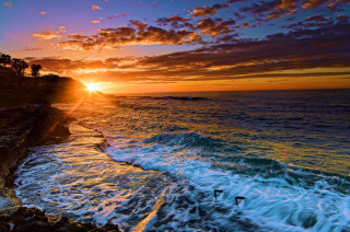 Sunset ocean waves crashing swimmer - a sunset over the ocean free wallpaper