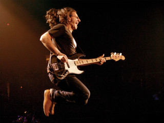 Man jumping guitar stage microphone - cliff childs free wallpaper