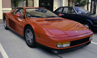 Red sports car man building - it in front free wallpaper