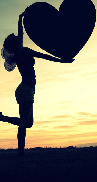 Woman holding heart sunset arms - dawn free wallpaper