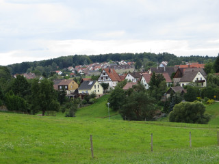 Green field houses hill fence - a hill in the background free wallpaper