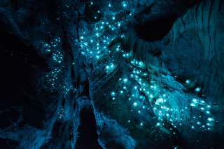 Cave lights man standing middle - a cave free wallpaper
