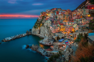Small village cliff ocean dusk - a body of water below free wallpaper