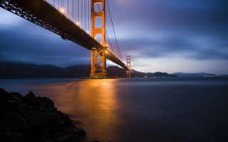 Bridge night water lights mountain - a large bridge over a body of water free wallpaper
