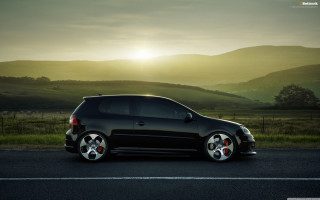 Black car parked road grass - a black car free wallpaper for desktop