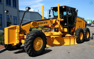 Yellow tractor parking lot building - matte finish free wallpaper