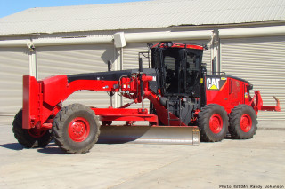 Red tractor snow plow building - front view free wallpaper
