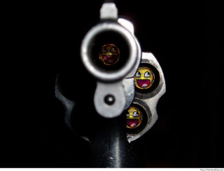 Gun smiley face barrel cap 2 - a close up of a gun free wallpaper