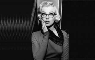 Woman glasses scarf microphone leaning - against a wall free wallpaper