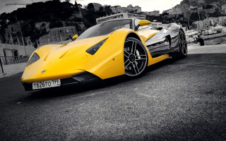 Yellow sports car parking lot 29 - a hill in the background free wallpaper