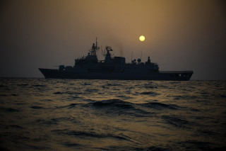 Large ship ocean sunset sun - hazy free wallpaper