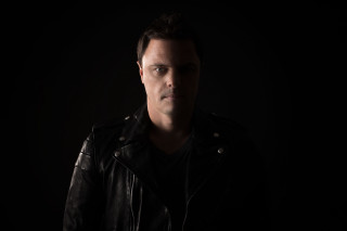 Man black jacket serious look 6 - studio portrait free wallpaper