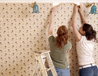 Women painting wallpaper ladder wall - blunt free wallpaper