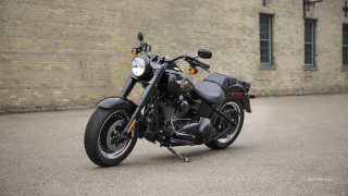 Motorcycle parked brick building wall - a brick wall behind free wallpaper