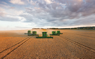 Large field farm equipment cloudy - a large field free wallpaper