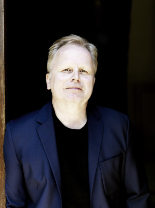 Man suit black shirt doorway - his hands in his pockets free wallpaper