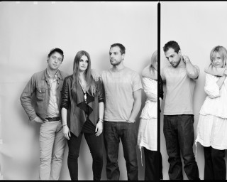 Group people standing room wall 3 - a wall behind them free wallpaper