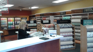 Woman sitting desk store fabrics - a phone free wallpaper