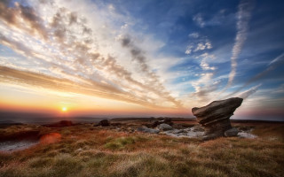 Rock formation grassy field sunset - a grassy field free wallpaper