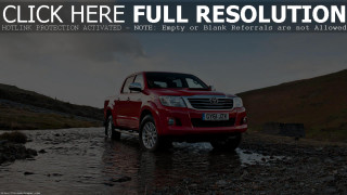 Red truck driving river hill - a river next free wallpaper