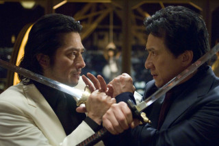 Suits swords facing hands together - a building in the background free wallpaper