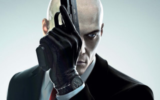Man suit gun serious look 2 - a man in a suit holding free wallpaper