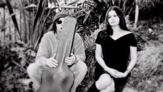 Man woman guitar case outdoors - a man and a woman sitting next free wallpaper