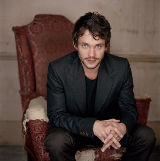 Man sitting chair hands folded 3 - a portrait free wallpaper
