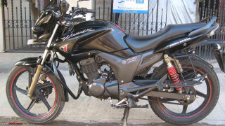 Motorcycle parked street fence gated - front view free wallpaper