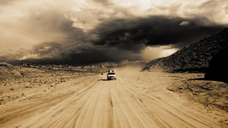 Truck dirt road cloudy sky - a mountain in the distance free wallpaper