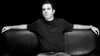 Man sitting couch arms crossed 4 - studio portrait free wallpaper
